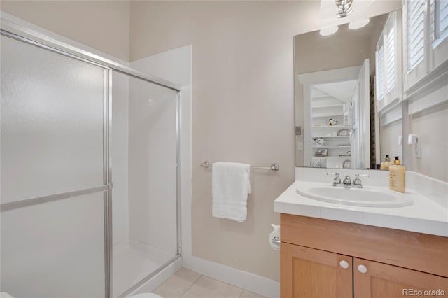 11776 Perry St, Westminster, CO 80031 - bathroom featuring vanity, baseboards, tile patterned floors, and a shower stall