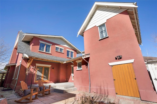 11776 Perry St, Westminster, CO 80031 - view of front of property with roof with shingles, stucco siding, and a patio area