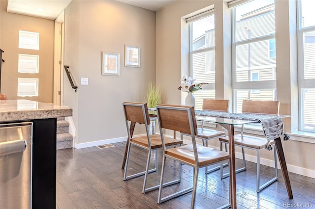 15738 E Broncos Pl, Englewood, CO 80112 - dining space featuring plenty of natural light, dark wood finished floors, and stairs