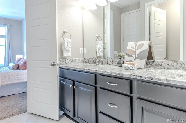 15738 E Broncos Pl, Englewood, CO 80112 - full bathroom with double vanity, connected bathroom, and tile patterned flooring