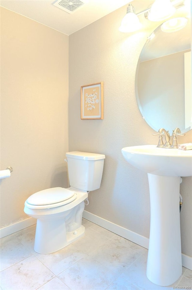 15738 E Broncos Pl, Englewood, CO 80112 - half bath featuring toilet and tile patterned floors