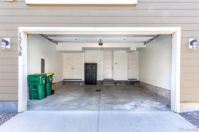 15738 E Broncos Pl, Englewood, CO 80112 - garage featuring concrete driveway and electric panel