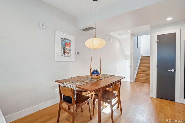 dining room with baseboards, visible vents, light wood-style flooring, stairs, and recessed lighting