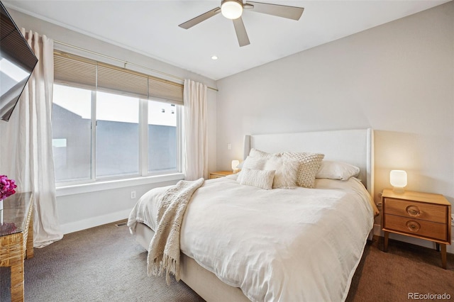 bedroom with ceiling fan, dark carpet, and vaulted ceiling