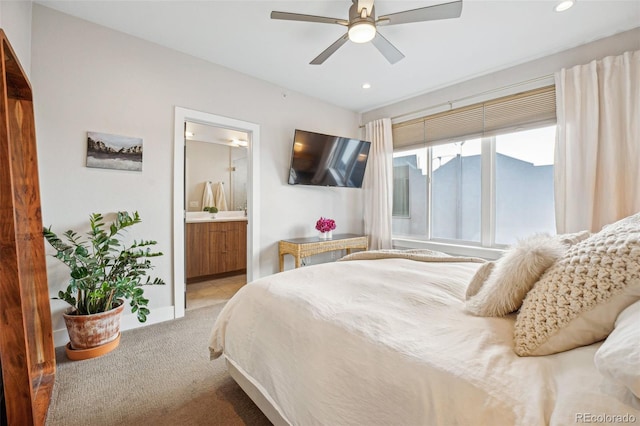 carpeted bedroom with ceiling fan and ensuite bathroom