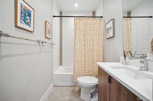 bathroom featuring a textured wall, toilet, shower / bath combo, vanity, and tile patterned floors