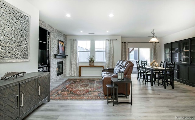 living room with a fireplace and light hardwood / wood-style flooring