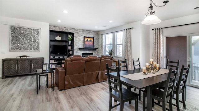 dining area featuring a fireplace and light hardwood / wood-style floors