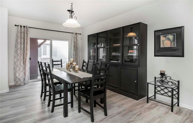 dining space with light hardwood / wood-style floors