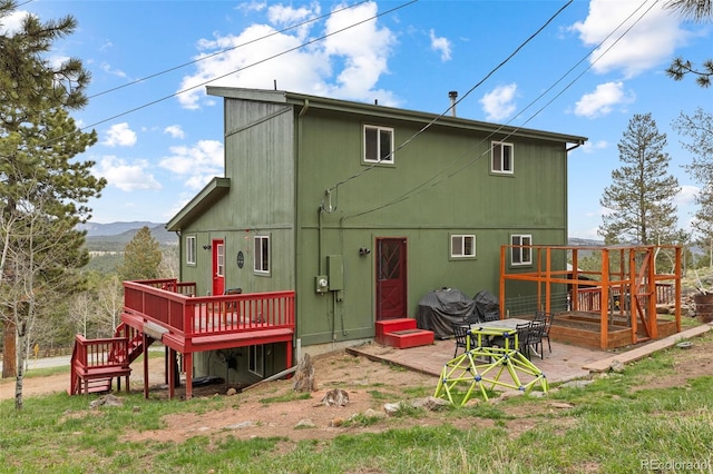 518 Pine Dr, Bailey, CO 80421 - rear view of property with a deck with mountain view and a patio