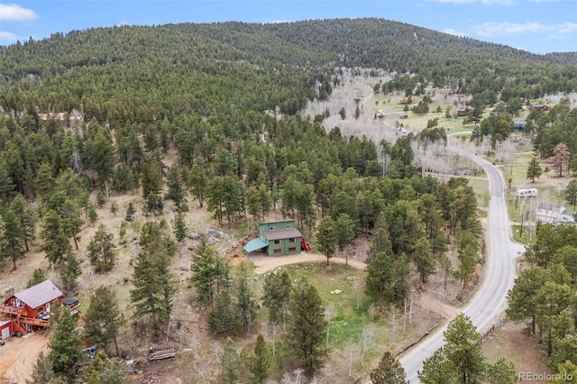 518 Pine Dr, Bailey, CO 80421 - view from above of property featuring a heavily wooded area and a mountainous background