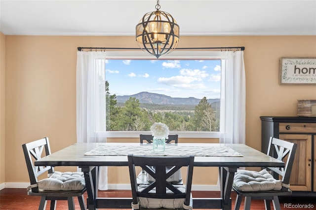 518 Pine Dr, Bailey, CO 80421 - dining area with wood finished floors, a mountain view, and a chandelier