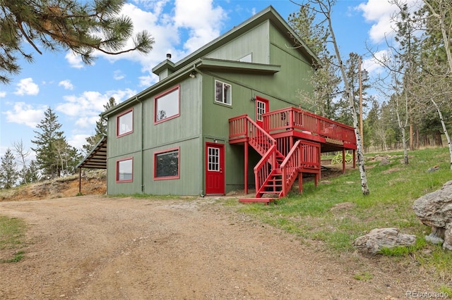 518 Pine Dr, Bailey, CO 80421 - view of front of property with stairway, a deck, and driveway