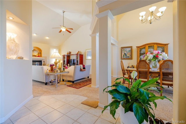 interior space featuring high vaulted ceiling and ceiling fan with notable chandelier