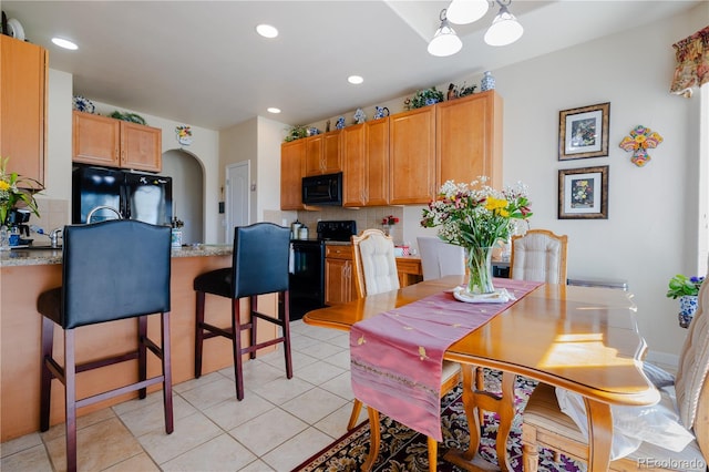 dining space featuring light tile patterned flooring