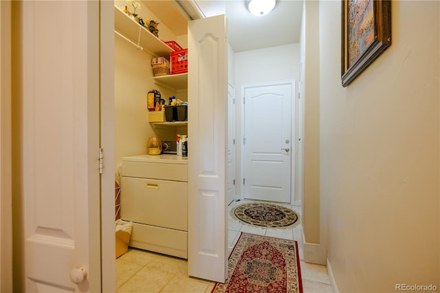 interior space with light tile patterned flooring and washer / dryer