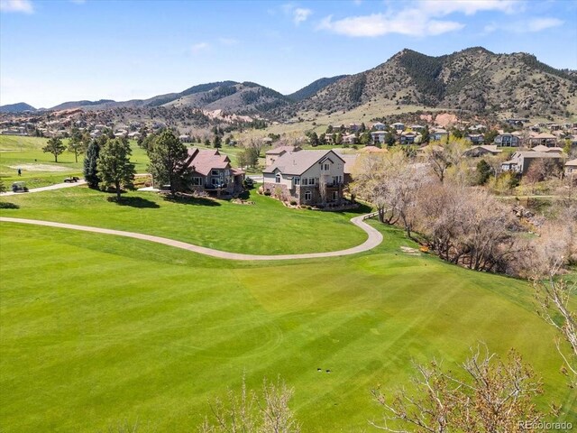 birds eye view of property featuring view of golf course, a residential view, and a mountain view