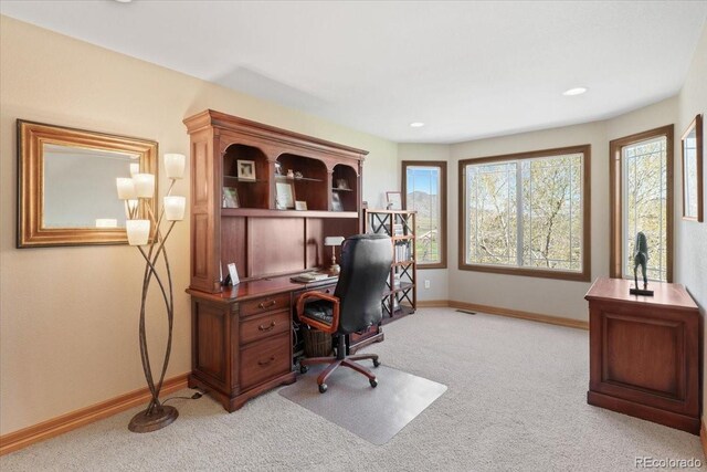 office area with baseboards and light carpet