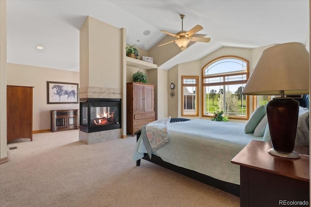 carpeted bedroom featuring baseboards, a multi sided fireplace, and vaulted ceiling
