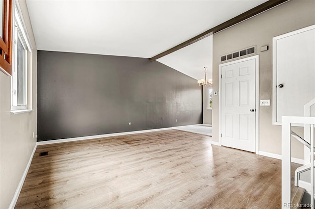 foyer featuring a chandelier, wood finished floors, and healthy amount of natural light