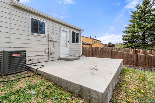 view of patio featuring central air condition unit and fence