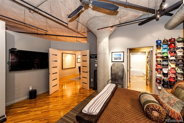 1863 Wazee St Unit 4B, Denver, CO 80202 - bedroom featuring wood finished floors, ensuite bathroom, baseboards, and track lighting