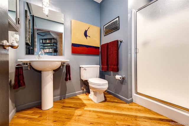 1863 Wazee St Unit 4B, Denver, CO 80202 - bathroom featuring wood finished floors, a stall shower, and toilet