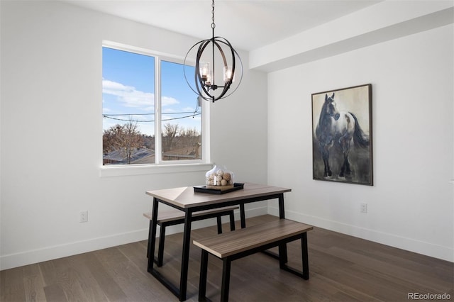 dining room featuring dark hardwood / wood-style floors and an inviting chandelier