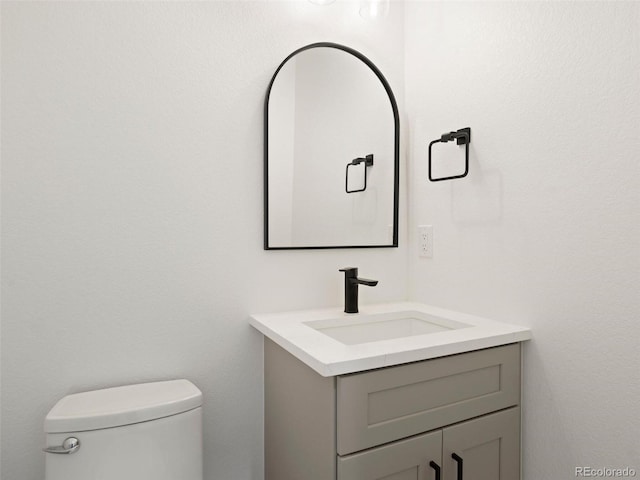 bathroom with toilet and vanity