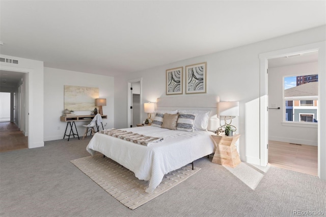 bedroom featuring light colored carpet