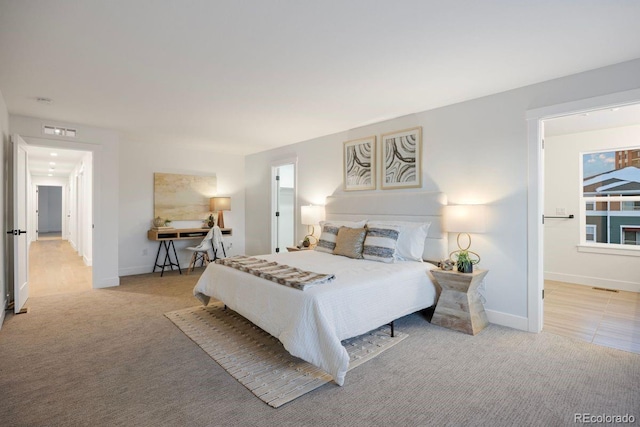 bedroom featuring light carpet