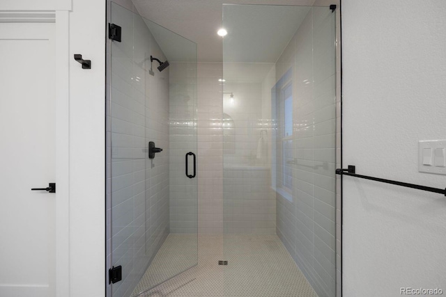 bathroom with a shower with shower door