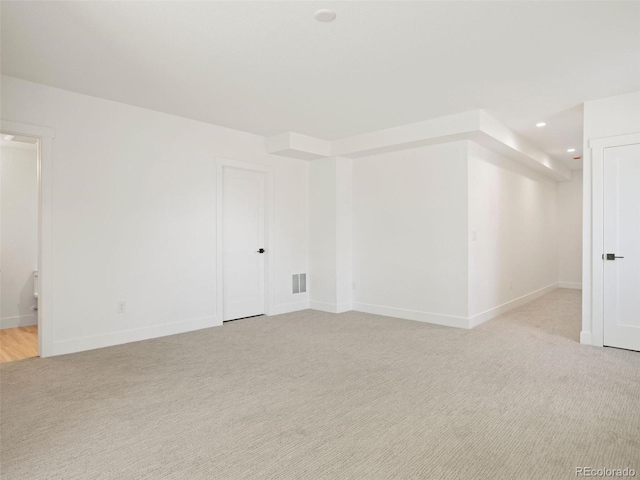 empty room featuring light colored carpet