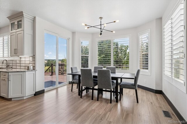 5665 Vistancia Ct, Parker, CO 80134 - dining area with a chandelier and light wood-type flooring