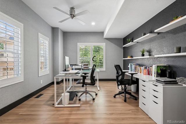 5665 Vistancia Ct, Parker, CO 80134 - home office with light wood-style flooring, ceiling fan, and a textured wall