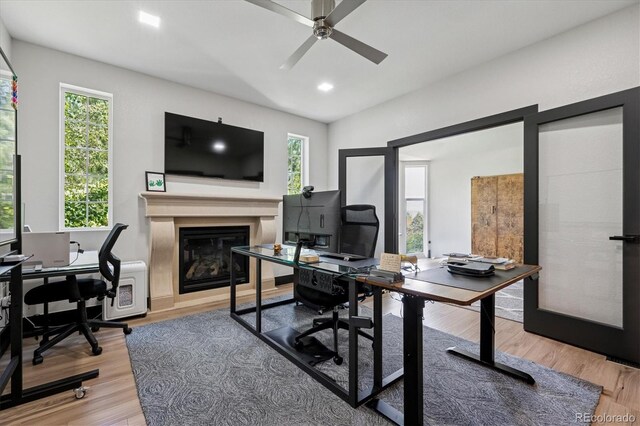 5665 Vistancia Ct, Parker, CO 80134 - office space featuring a ceiling fan, a glass covered fireplace, healthy amount of natural light, wood finished floors, and recessed lighting