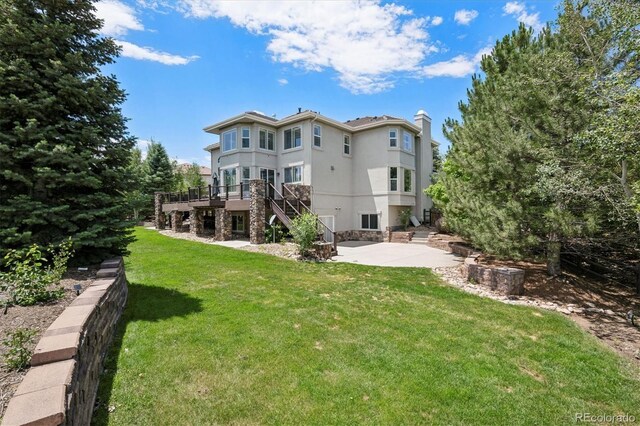 5665 Vistancia Ct, Parker, CO 80134 - rear view of property with a patio area, stairs, a deck, a chimney, and stucco siding