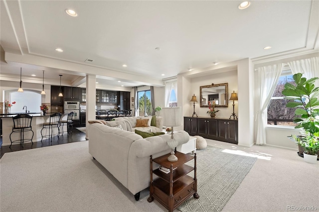 carpeted living room featuring visible vents and recessed lighting