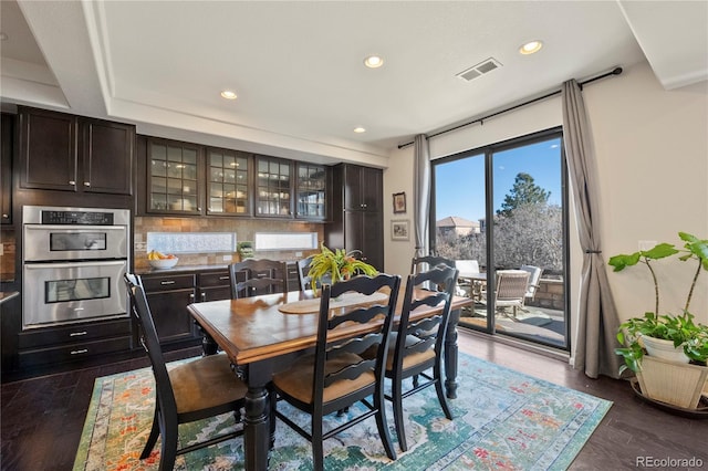 dining room with visible vents, dark wood-type flooring, and recessed lighting