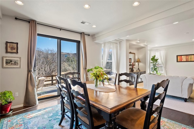 dining room featuring recessed lighting, visible vents, plenty of natural light, and wood finished floors