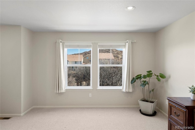 carpeted empty room with recessed lighting, visible vents, and baseboards