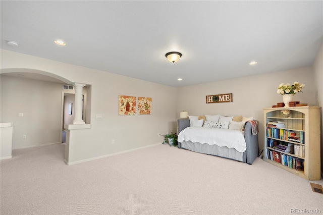 carpeted bedroom with arched walkways, recessed lighting, visible vents, baseboards, and ornate columns