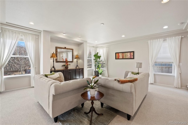 living room with light carpet, a wealth of natural light, and baseboards