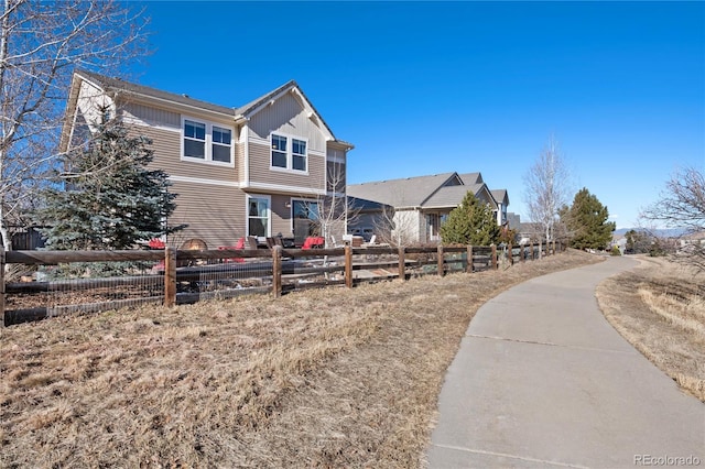 exterior space with board and batten siding and fence