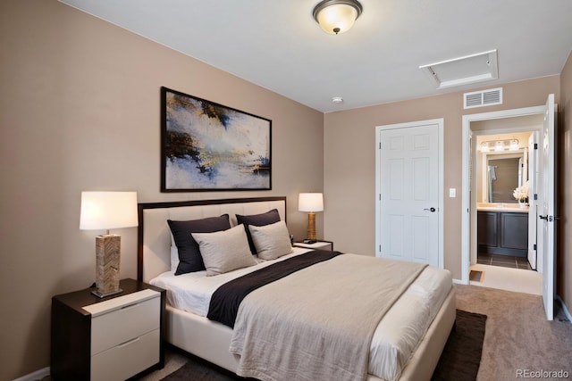 carpeted bedroom featuring attic access, visible vents, and baseboards