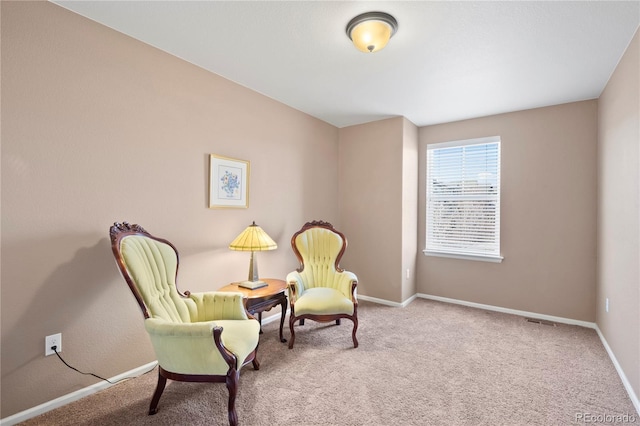 living area with carpet flooring and baseboards