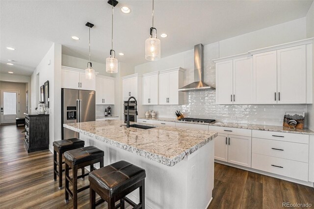 7169 Canyon Sky Trl, Castle Pines, CO 80108 - kitchen featuring wall chimney exhaust hood, stainless steel appliances, recessed lighting, dark wood-style floors, and decorative backsplash