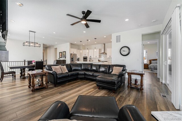 7169 Canyon Sky Trl, Castle Pines, CO 80108 - living room with ceiling fan, wood finished floors, and recessed lighting