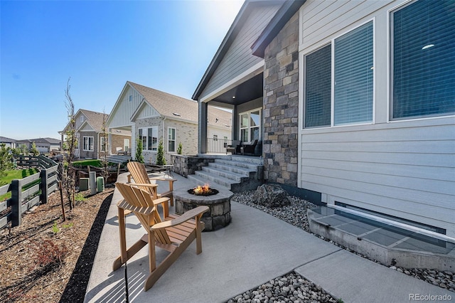 7169 Canyon Sky Trl, Castle Pines, CO 80108 - covered porch with an outdoor fire pit, a residential view, and a patio area