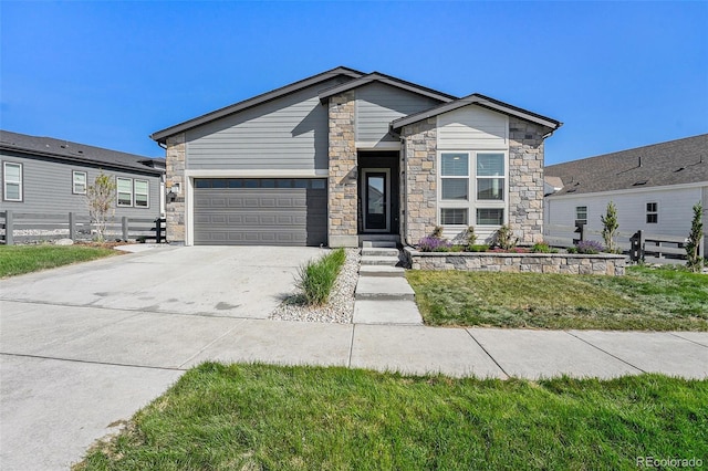 7169 Canyon Sky Trl, Castle Pines, CO 80108 - view of front of house with stone siding, an attached garage, and concrete driveway
